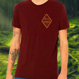 dark red shirt with a simple diagonal forest landscape and disc golf basket