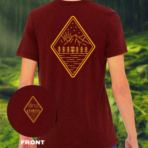 dark red shirt with a simple diagonal forest landscape and disc golf basket